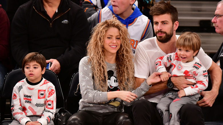 Shakira, Gerard Piqué, and their children at a sports game