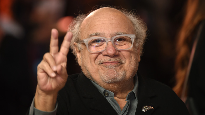 Danny DeVito flashes peace sign