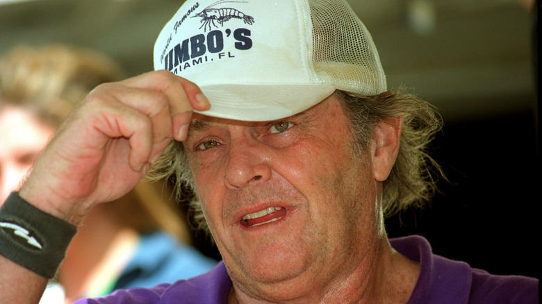 Jack Nicholson holding peak of baseball cap