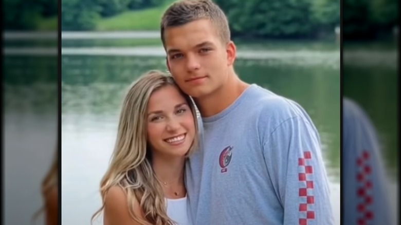 Katie Feeney and Sean Yamada hugging by lake