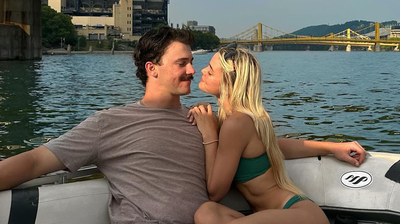 Paul Skenes and Olivia Dunne snuggling on a boat