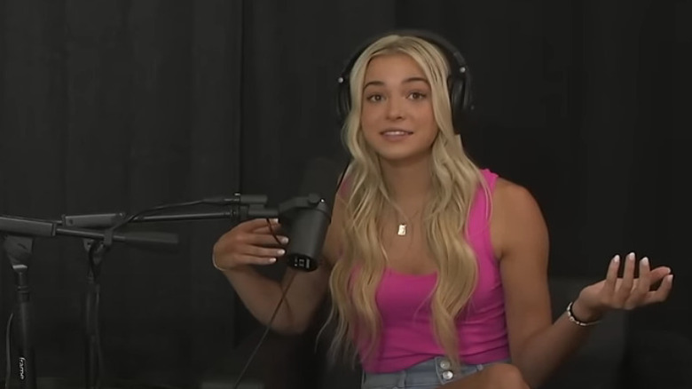 Olivia Dunne during podcast appearance wearing a pink shirt