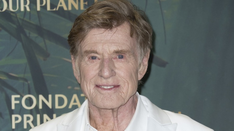 Robert Redford posing in a white shirt