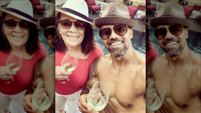 Shemar Moore and his mother pose with wine glasses