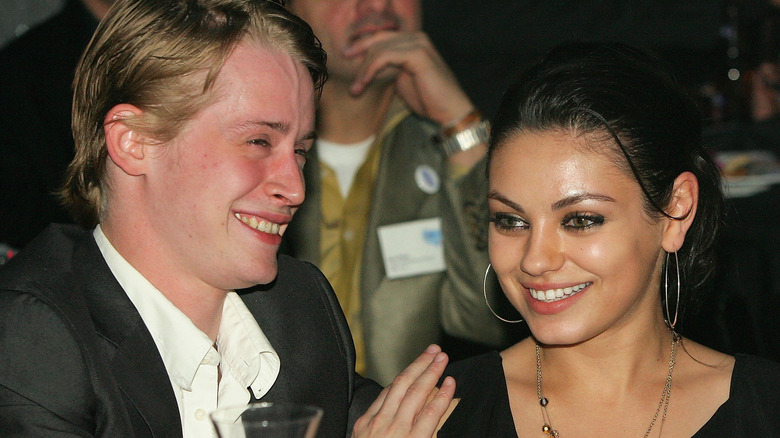 Macaulay Culkin and Mila Kunis laughing