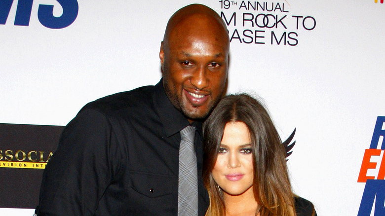 Khloé Kardashian and Lamar Odom posing on a red carpet