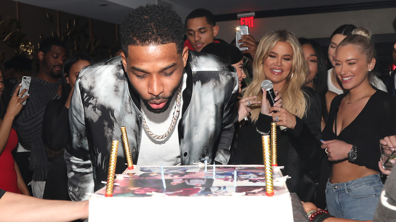 Khloé Kardashian cheering on Tristan Thompson as he blows out birthday candles