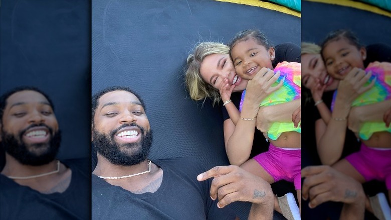 Tristan Thompson, Khloé Kardashian, and their daughter True smiling in an Instagram selfie