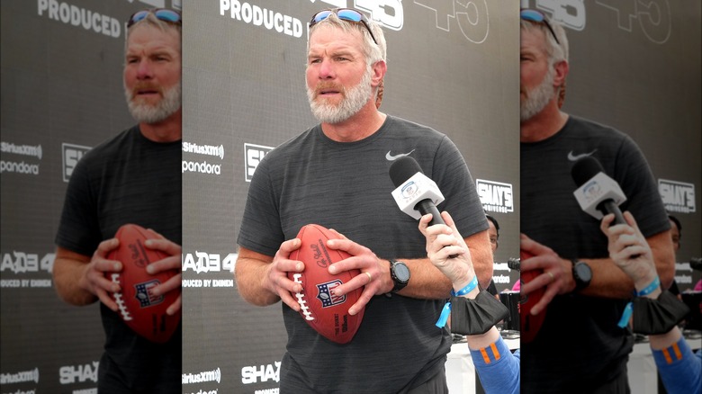 Brett Favre holding football