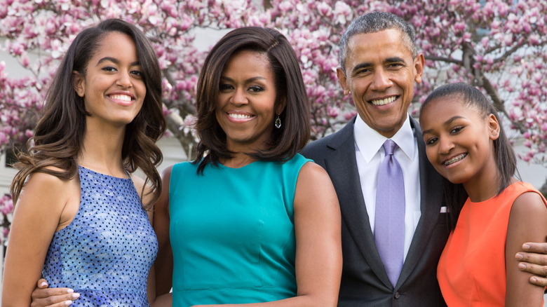 Malia, Michelle, Barack, and Sasha Obama smiling