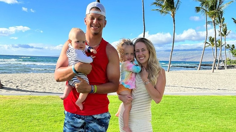 Patrick and Brittany Mahomes hold their kids