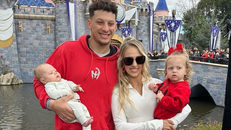 Patrick and Brittany Mahomes hold their children