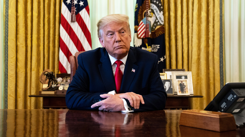 Donald Trump at the Resolute Desk with what appears to be his Diet Coke button