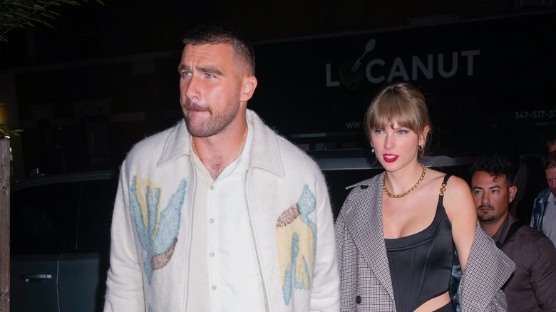 Travis Kelce and Taylor Swift holding hands