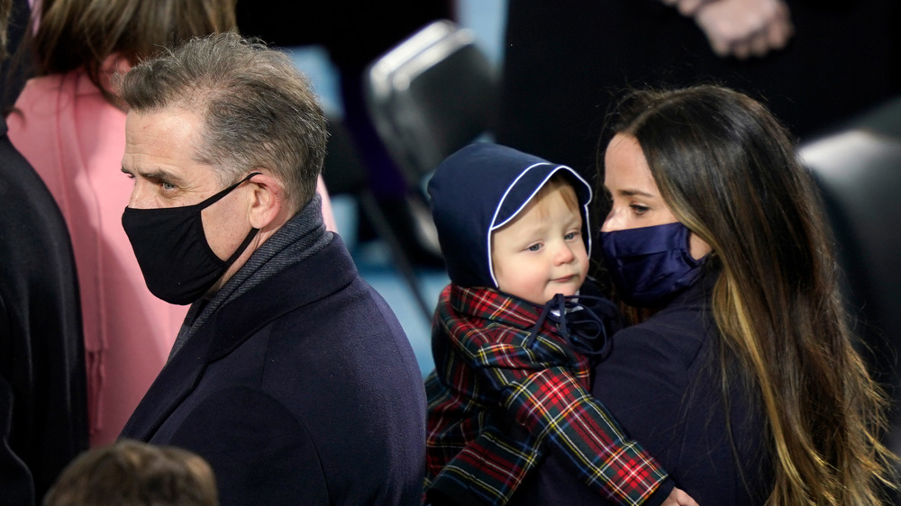 Hunter Biden staring, Ashley Biden holding Beau Biden