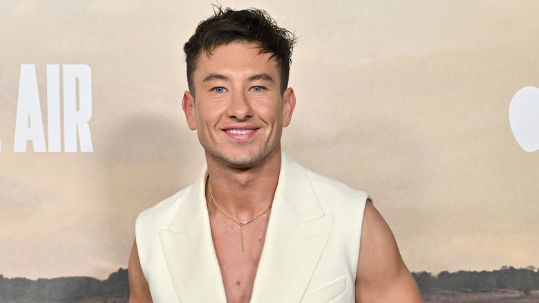 Barry Keoghan smiles in a white suit