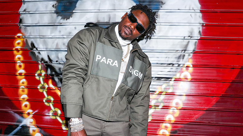 Antonio Brown posing for in front of painted garage door