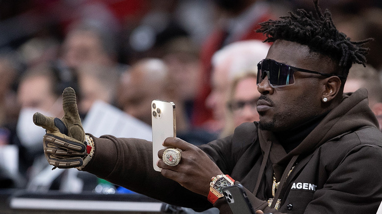 Antonio Brown taking pictures with his phone at a game