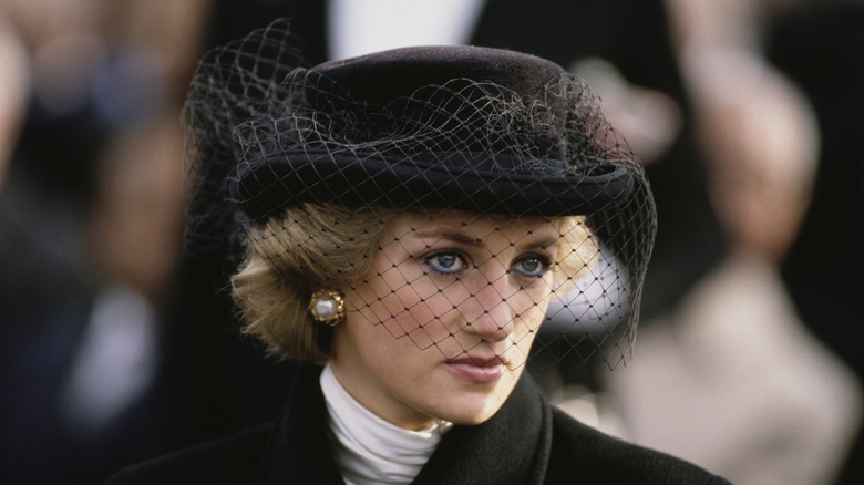 Princess Diana with hat covering face