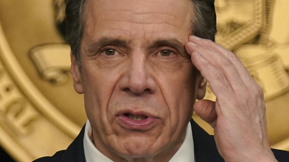 Andrew Cuomo rubs his temple