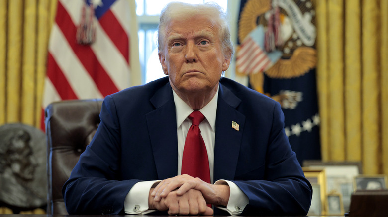 Donald Trump at his desk in the oval office.