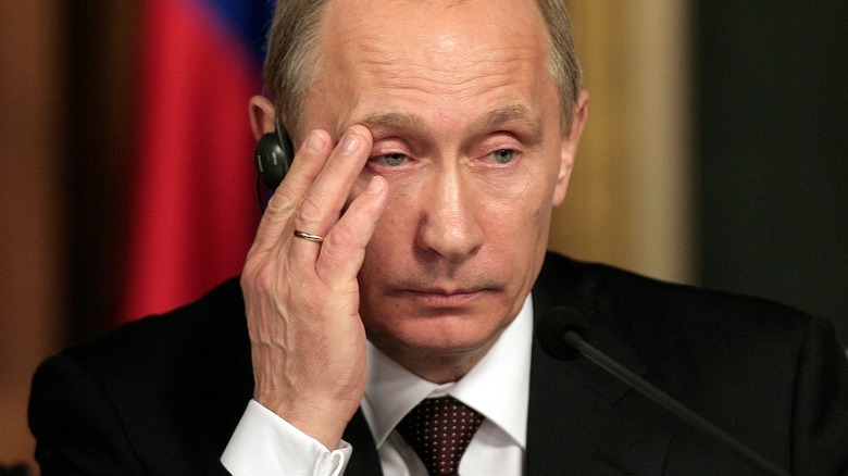 Vladimir Putin with his hands to his head