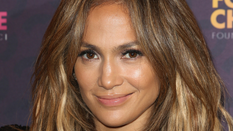 Jennifer Lopez smiling on a red carpet