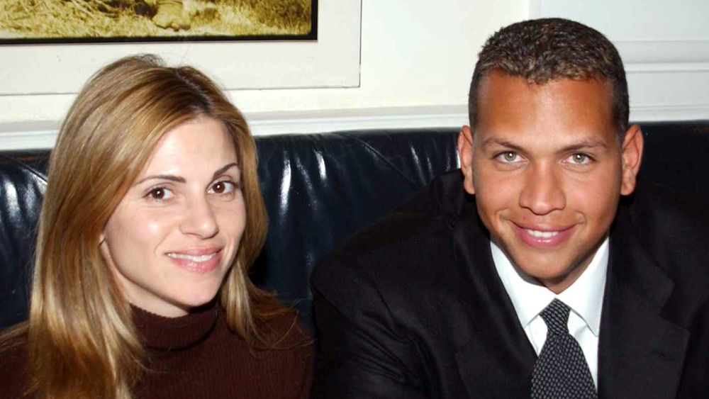 Cynthia Scurtis and Alex Rodriguez seated on a couch, smiling 