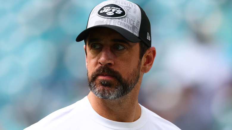 Aaron Rodgers wearing Jets cap