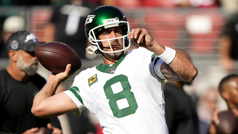 Aaron Rodgers mid-throw on field