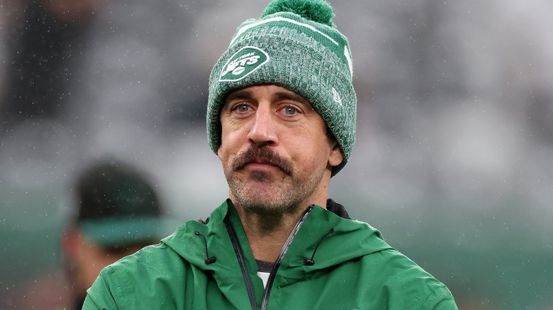 Aaron Rodgers wearing Jets beanie on field