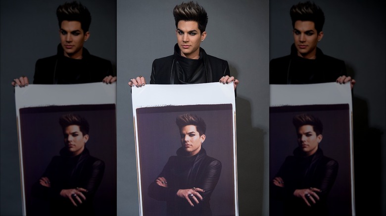 Adam Lambert holding photo of himself