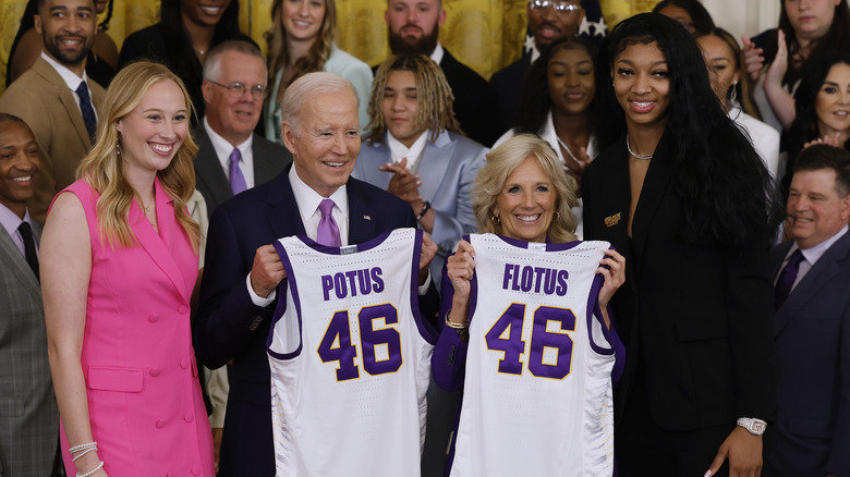 Angel Reese posing with Joe and Jill Biden