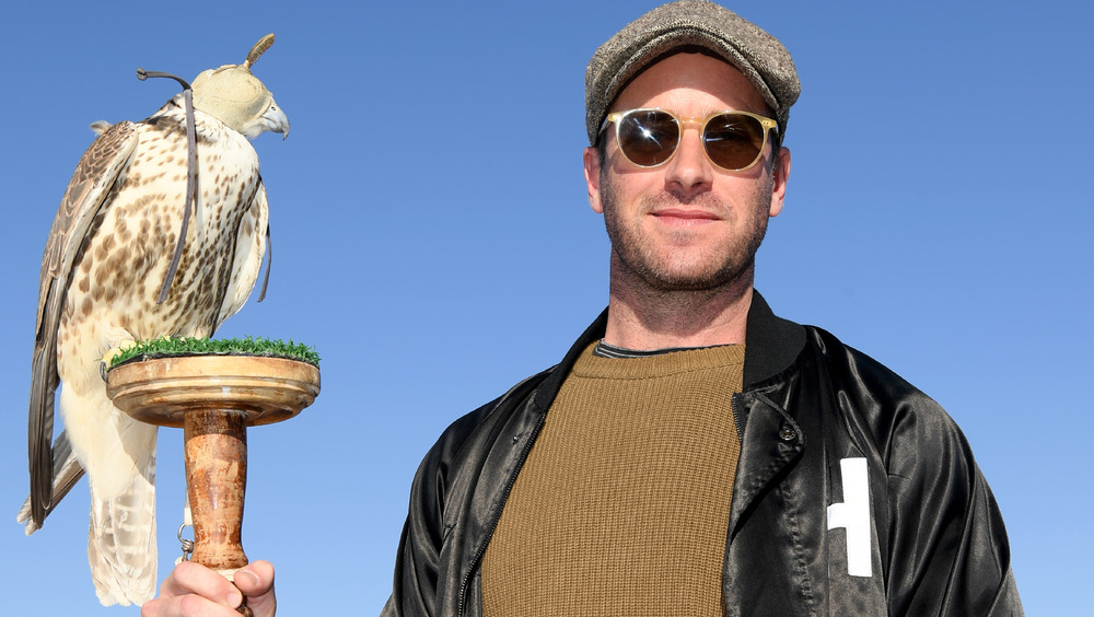 Armie Hammer holds a hawk in Saudi Arabia