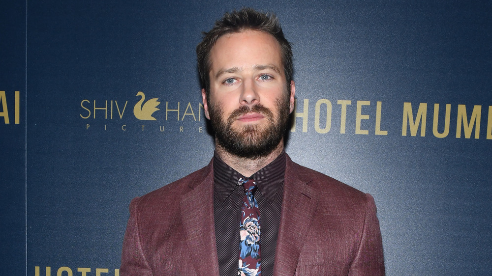 A bearded Armie Hammer looking serious at a Hotel Mumbai screening