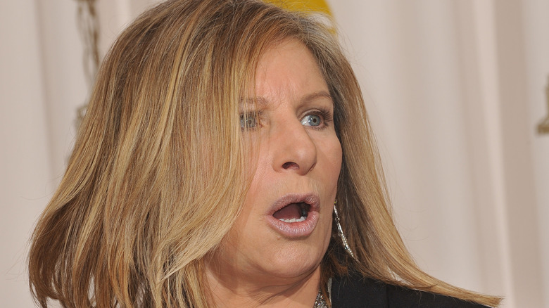 Barbra Streisand on red carpet, mouth open