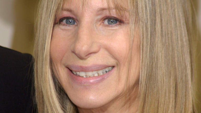 Barbra Streisand on red carpet, smiling