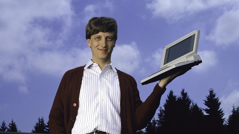 Bill Gates holding a computer