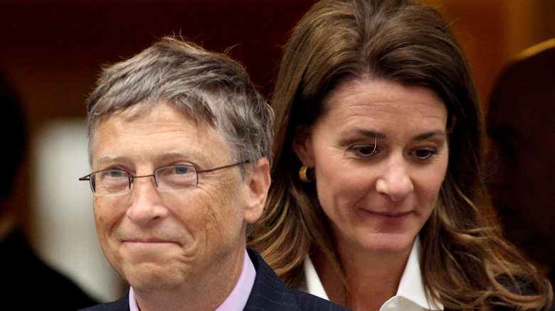 Bill Gates in front of Melinda Gates