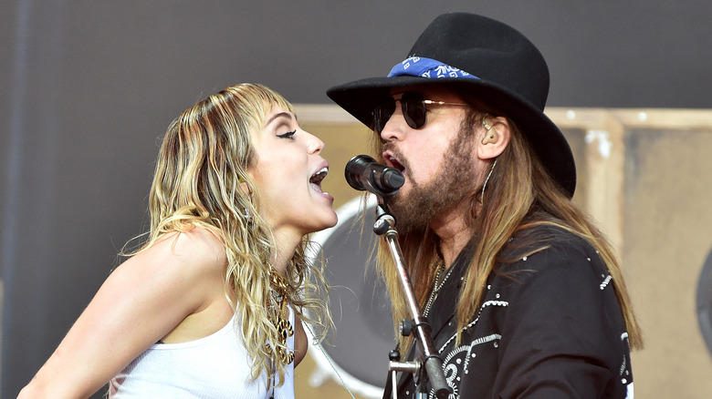 Billy Ray and Miley Cyrus perform together