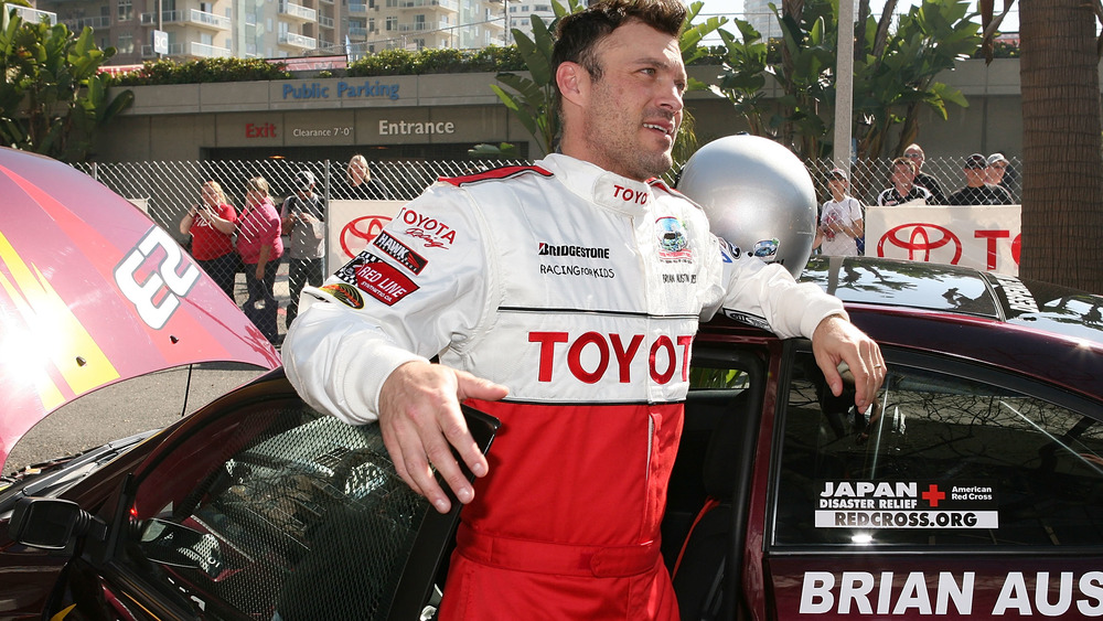 Brian Austin Green posing with his racecar