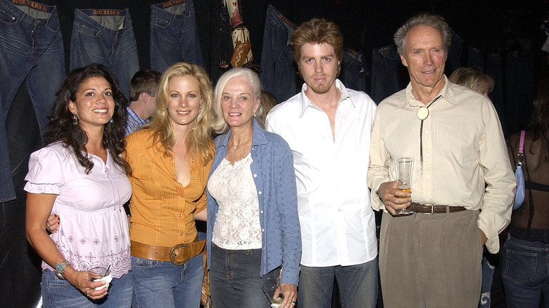 Clint Eastwood smiling with then-wife Dina Ruiz, first wife Maggie, and children Alison and Kyle