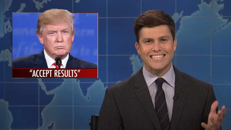 Colin Jost with over-the-shoulder Trump graphic