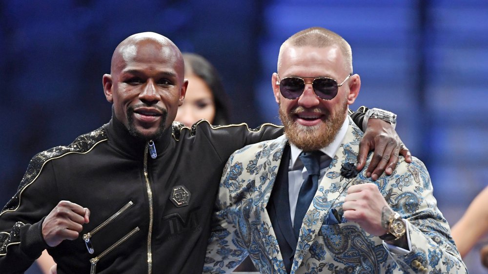 Floyd Mayweather and Conor McGregor with arms around one another