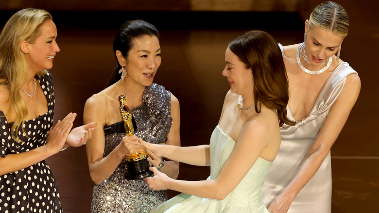 Jennifer Lawrence, Michelle Yeoh, Charlize Theron, and Emma Stone on the Oscars stage