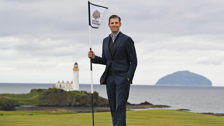 Eric Trump holding golf flag