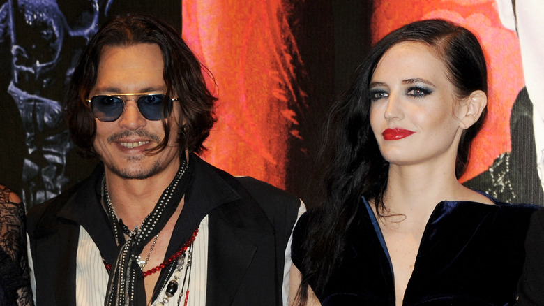 Johnny Depp smiling with Eva Green