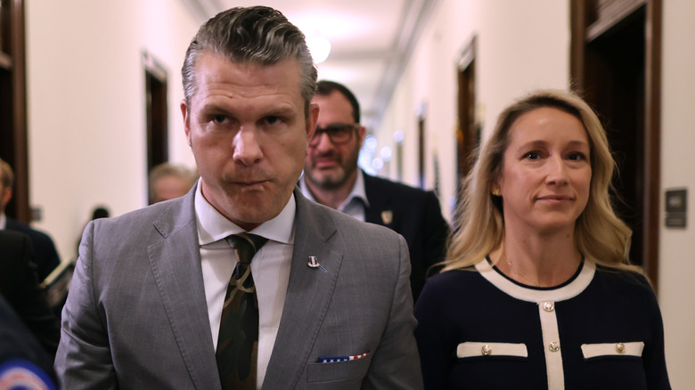 Pete Hegseth and wife Jennifer Rauchet walking down hallway in the Russell Senate Office Building