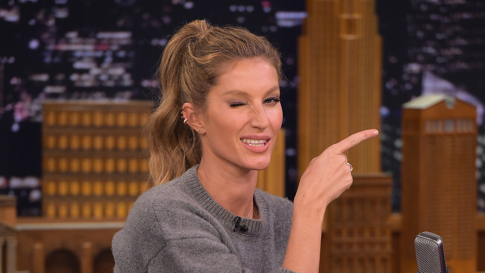 Gisele Bundchen winking and pointing 