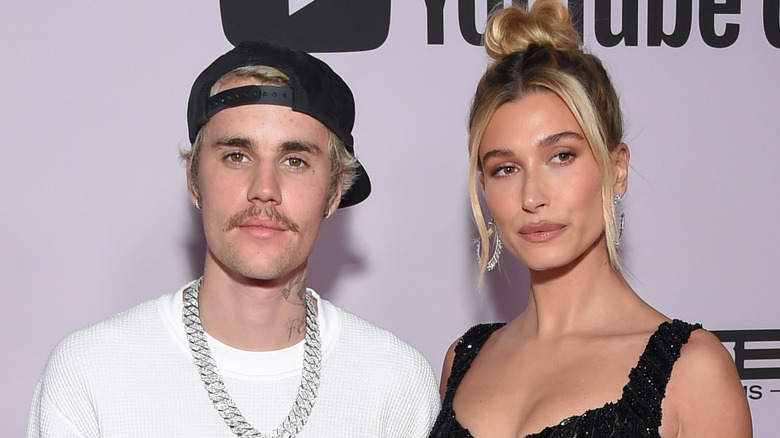 Justin Bieber baseball cap, Hailey Bieber smiling